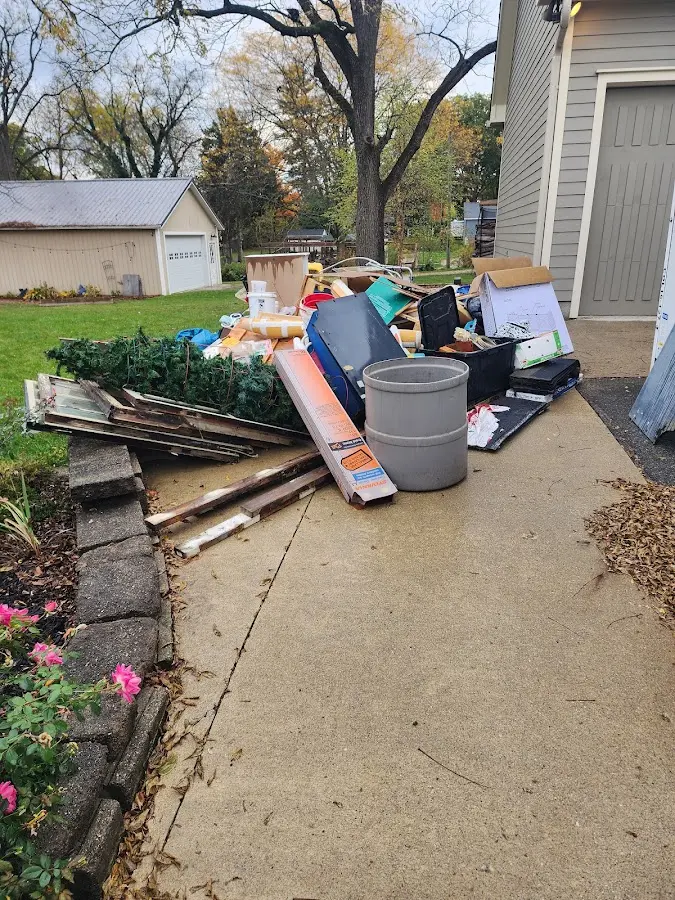 Dumpster being loaded with debris for Estate Cleanout Dumpster Rental in Kingston